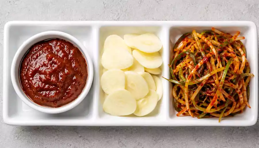 What is Samgyeopsal? Everything You Need to Know About Korean Pork BBQ 3 Ssamjang and garlic side dishes